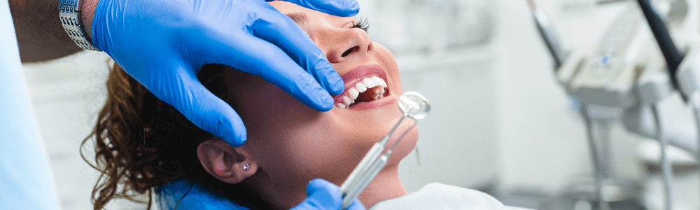 woman laying down on dental chair in Maidstone, kent getting dental implants