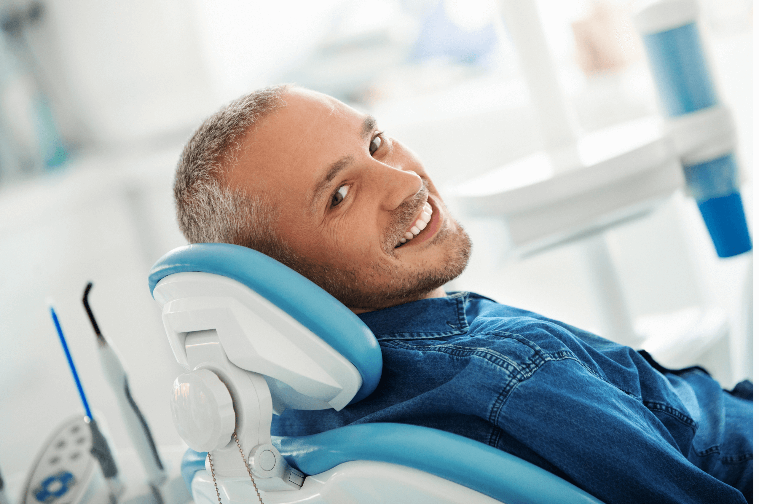 Man in dentist chair after getting dental implant treatment